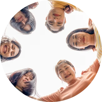 Group of teens forming a circle and smiling by facing downwards